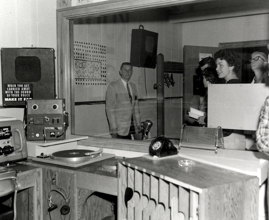 A photograph of students looking into Idaho's KUOI radio station.