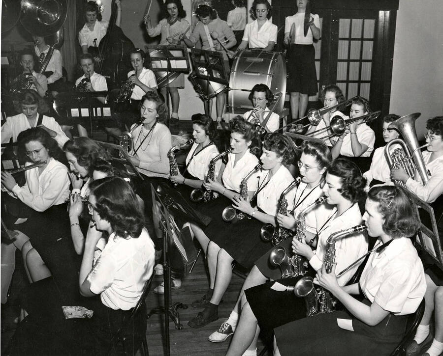 Idaho's All-Women band practices on stage. The saxophone section is the focus of this photograph.