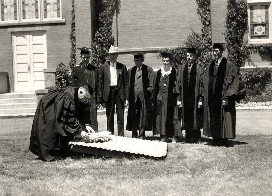 Regents burn bonds covering construction of Lindley Hall during Idaho's commencement. Pictured left to right: Honorable Asher B. Wilson, U of I president Mervin Gordon Neale, Ethel Steel, John S. Jenny and John W. Condie.