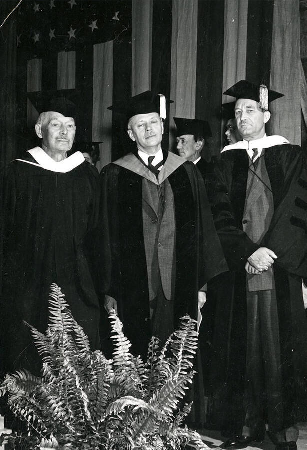 John Warren Brigham, president Harrison C. Dale, and Talbot Jennings stand together during commencement.