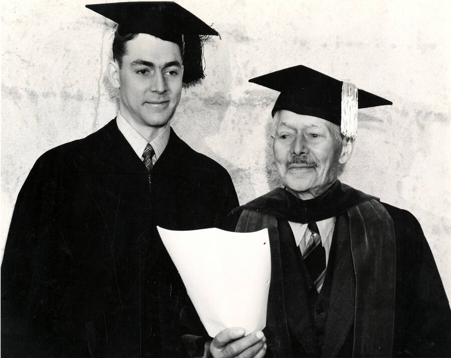 Morton Brigham receives a Bachelor of Science degree in Forestry and his father John Warren Brigham receives an honorary Bachelor of Arts degree at Idaho's commencement.