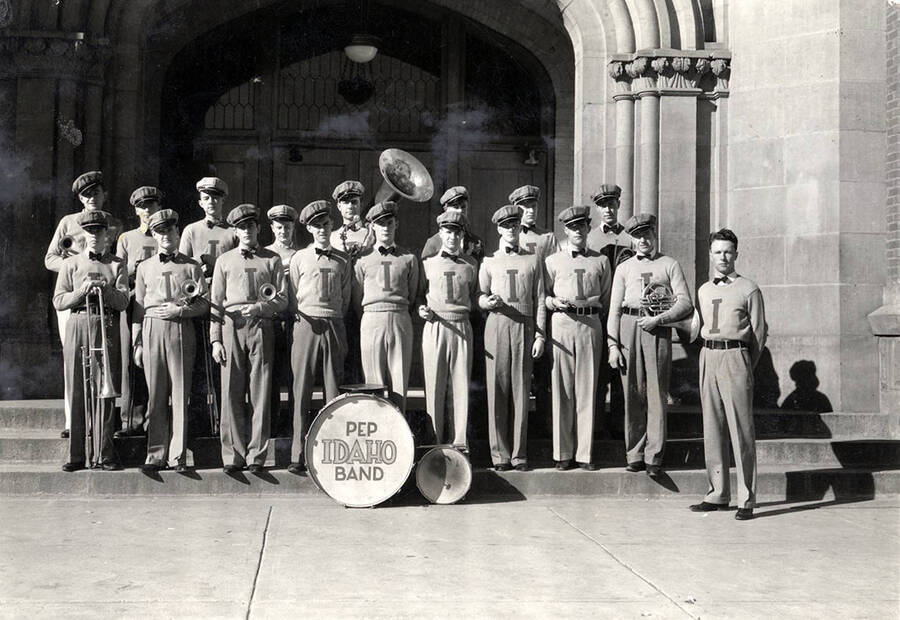 Idaho's pep band poses for a group photograph on the steps of the main entrance to the Administration Building. Students pictured: front row left to right: J. Wright, E. Pierce, P. Ennis, H. Reckord, W. Goss, J. Holt, C. Spear, J. Snodgrass, R. Thompson, R. Campbell; back row left to right: J. Armour, J. Gray, B. Seymour, d. Swingler, H. Nelson, S. Ryan, R. Radford, A. Blair.
