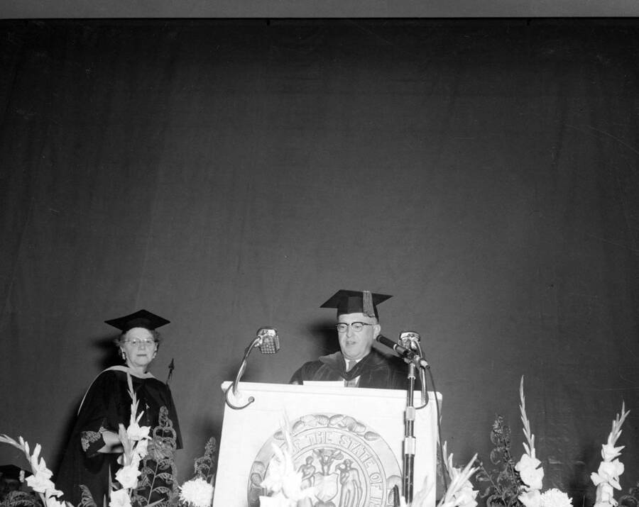 Idaho President Donald R. Theophilus reads the Citation of Merit after the retirement of Louise Carter, Dean of Women.