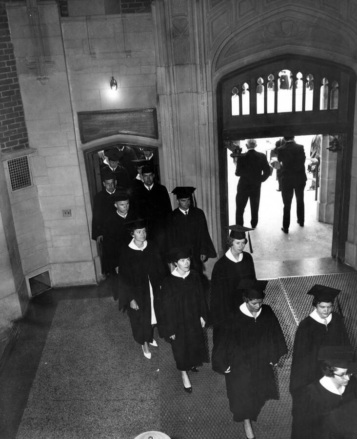 University of Idaho graduates file through the entrance of Memorial Gymnasium before commencement ceremonies.