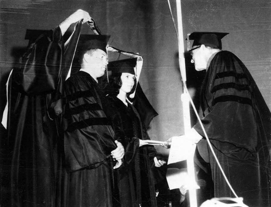 Allen and Sandra Clark were the first husband-wife duo to receive Ph.D.'s in the same field: geology. University of Idaho Dean David D. Kendrick hoods the couple.