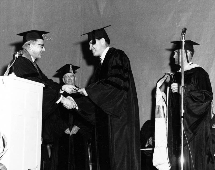 University of Idaho President Ernest W. Hartung congratulates and shakes hands with U.S. Senator Frank Church after awarding Church an honorary Doctorate of Law degree.