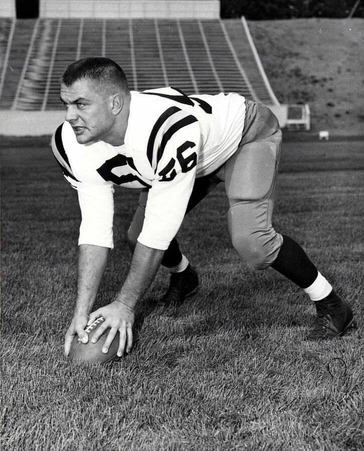 Football player Jim Decko preparing to hike the ball at the University of Idaho.