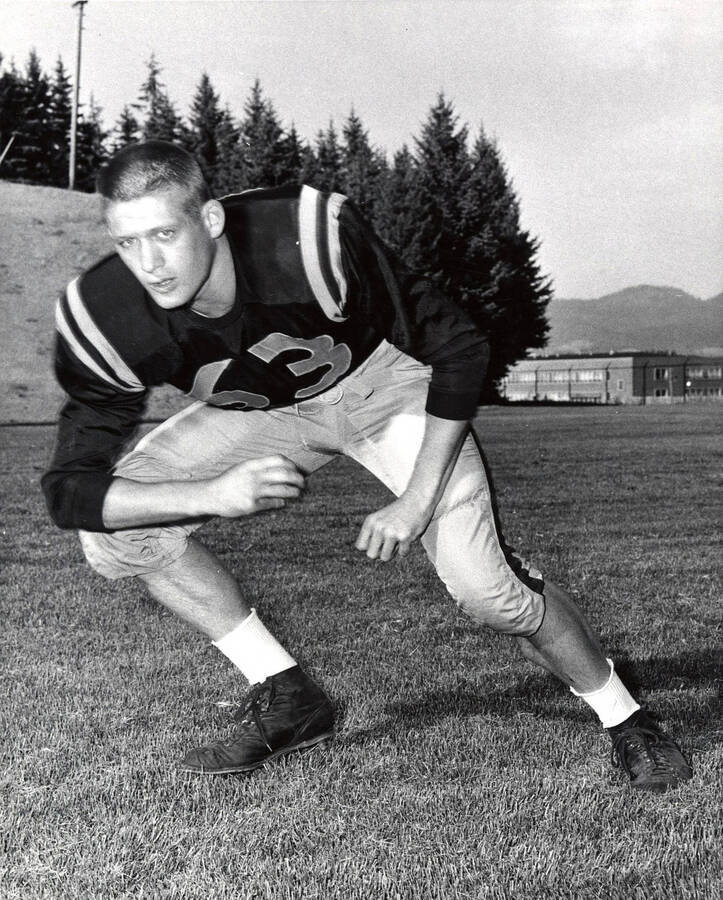 Football player Bill Hill (guard) on the University of Idaho field.