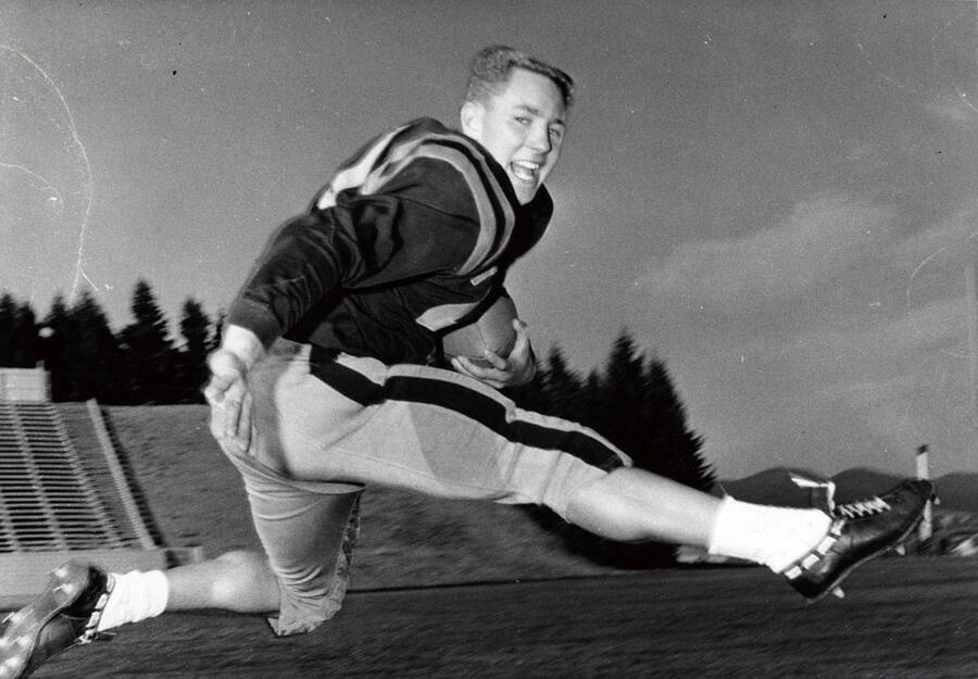 Football player Phil Steinbock (end) jumping with the ball.
