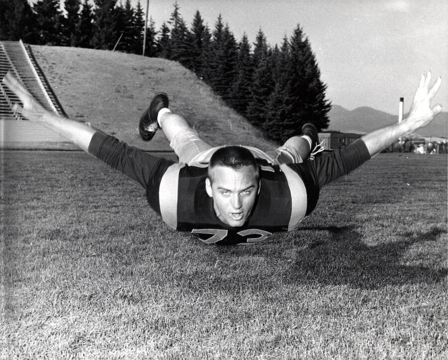 Football player Zeke Urko (tackle) hovering above the field at the University of Idaho.