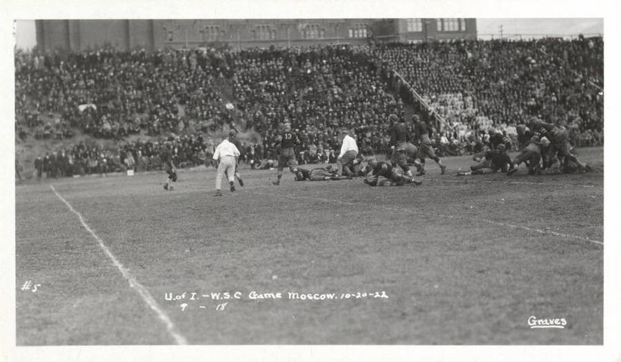 A photo taken during a University of Idaho vs. Washington State College football game with a caption that reads, 'U. of I. - W.S.C. Game. Moscow. 10-20-22, #5, 9-18.'