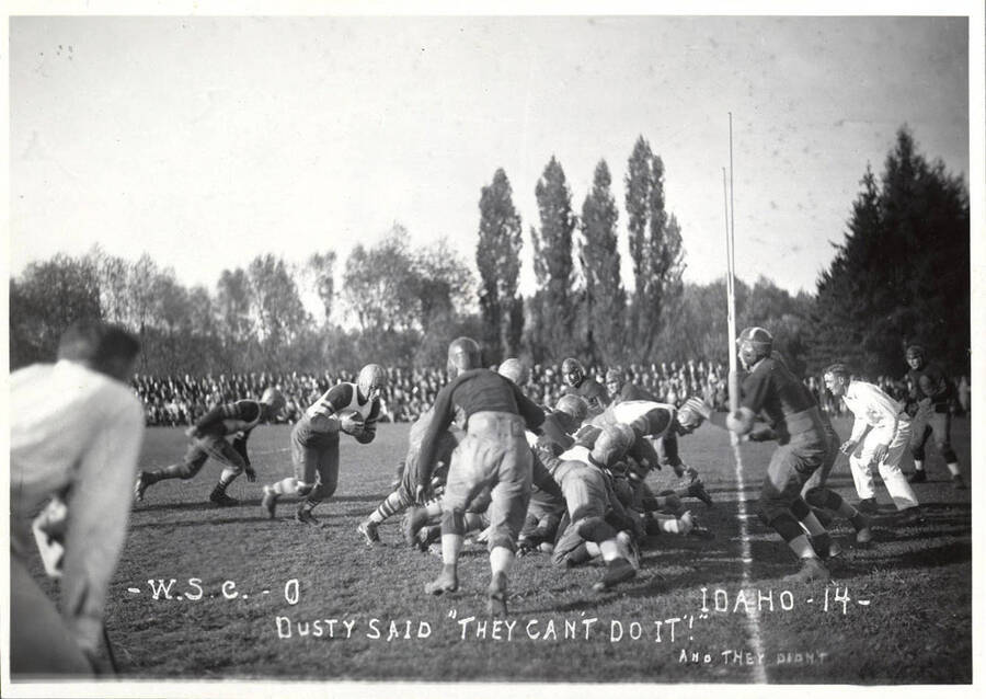 A photo taken during a University of Idaho vs. Washington State College football game with a caption that reads, 'W.S.C.-0, Dusty Said 'They Can't Do It! And They Didn't',  Idaho-14.'