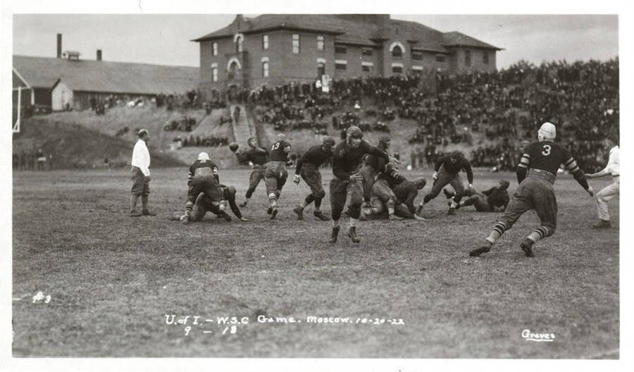 A photo taken during a University of Idaho vs. Washington State College football game with a caption that reads, 'U. of I. - W.S.C. Game. Moscow. 10-20-22, #3, 9-18.'