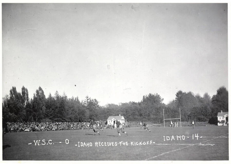 A photo taken during a University of Idaho vs. Washington State College football game with a caption that reads, 'W.S.C.-0 ~Idaho Receives the Kickoff~  Idaho-14.'