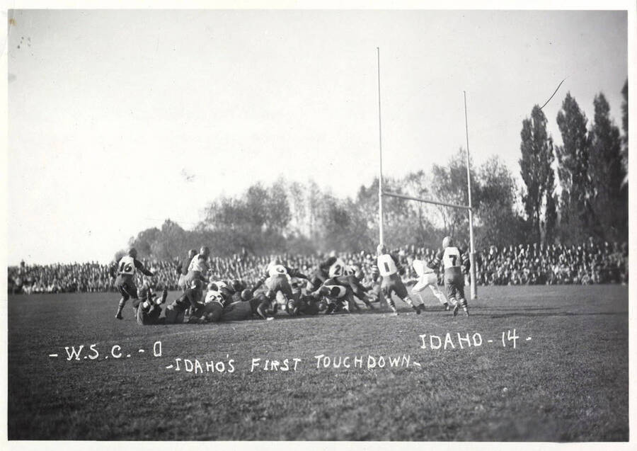 A photo taken during a University of Idaho vs. Washington State College football game with a caption that reads, 'W.S.C.-0 ~Idaho's First Touchdown~  Idaho-14.'