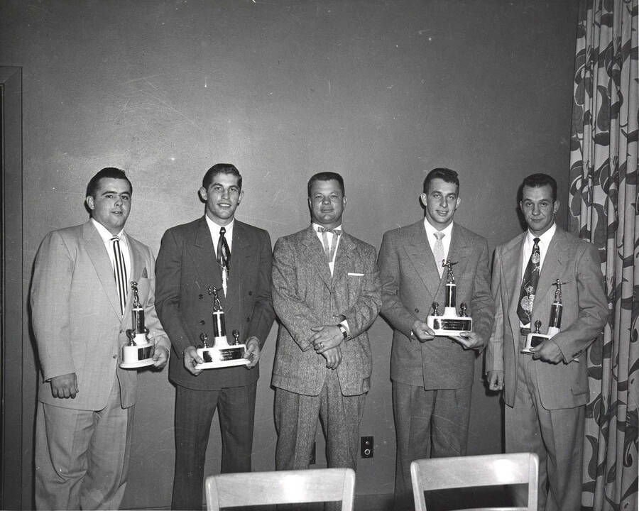 Pete Hester, Robert Holder, Babe Curfman, Mel Bertrand, and Ray Lewis receive football awards at the University of Idaho.