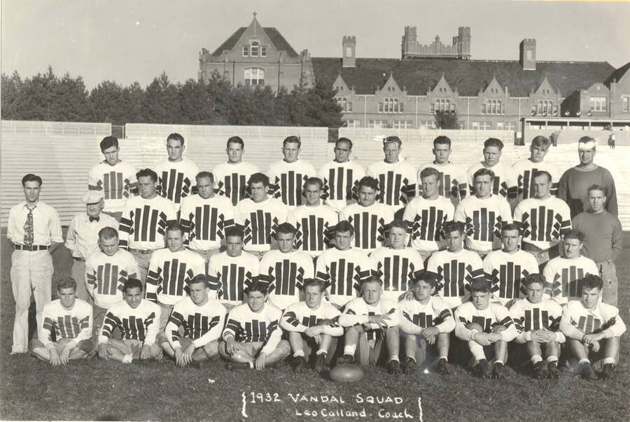 Photograph featuring the 1932 Idaho Vandals football team posing on MacLean Field, with the Administration Building in the background.