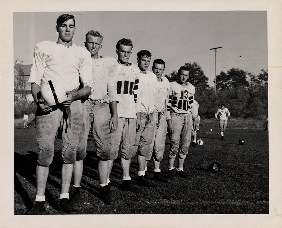 Six freshman football players pictured pregame, from left to right: John Thomas, Don Makinson, George Johnson, Ted Martin, Weldon Branch and James Price.