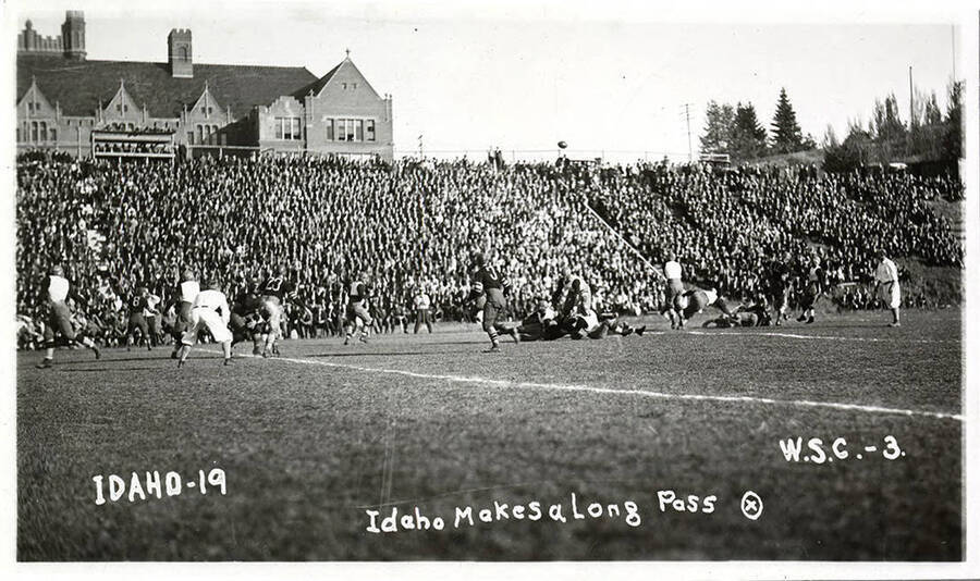 Idaho connects over the middle on a pass. Caption reads 'Idaho-19, Idaho Makes a Long Pass,  W.S.C.-3.'