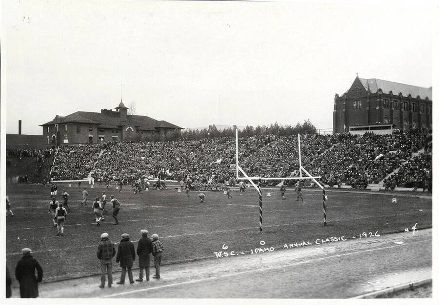 Players from both teams warm up prior to the second-half kickoff. Caption reads 'W.S.C.-6 - Idaho-0, Annual Classic - 1926, #4.'