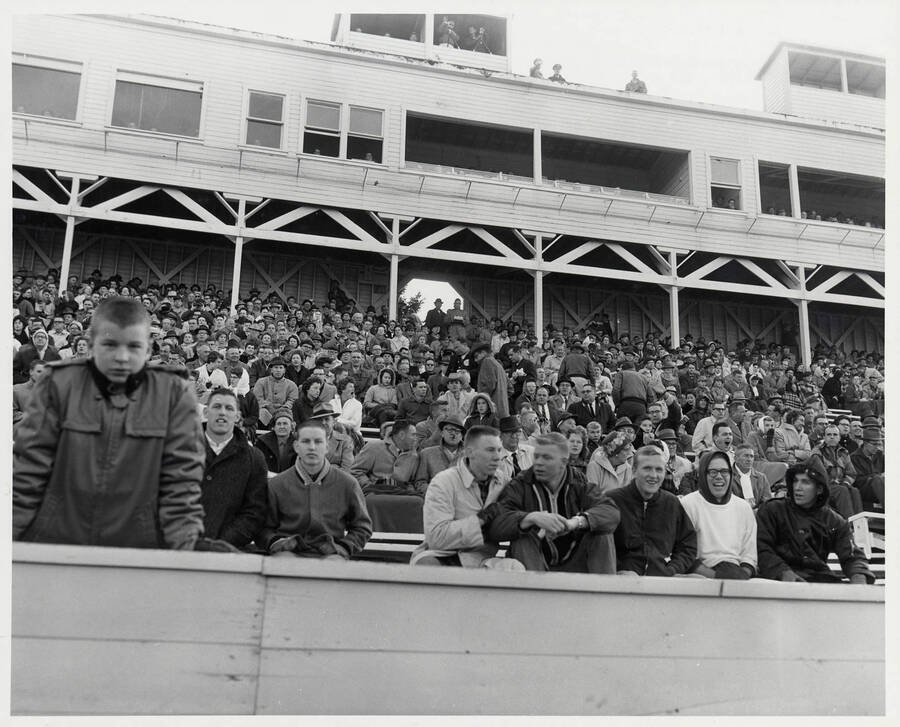 Alternative view of the seats under the press boxes. Several spectators can be seen looking and waving at the camera.