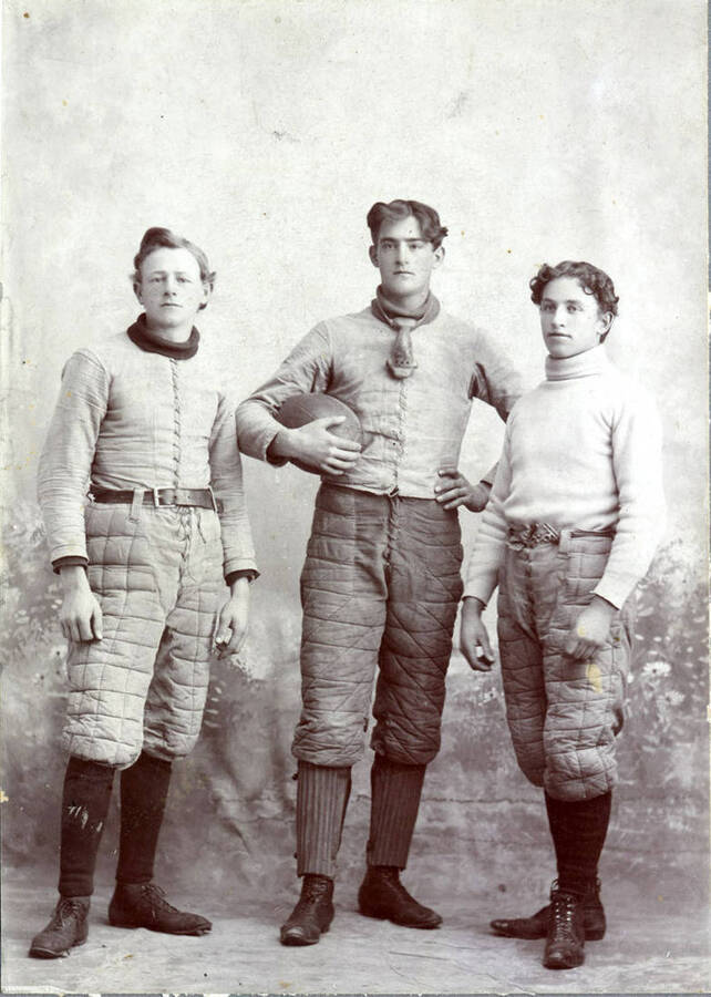 Portrait of football players Walter Taylor, George Horton and Frank Mix dressed in uniform.