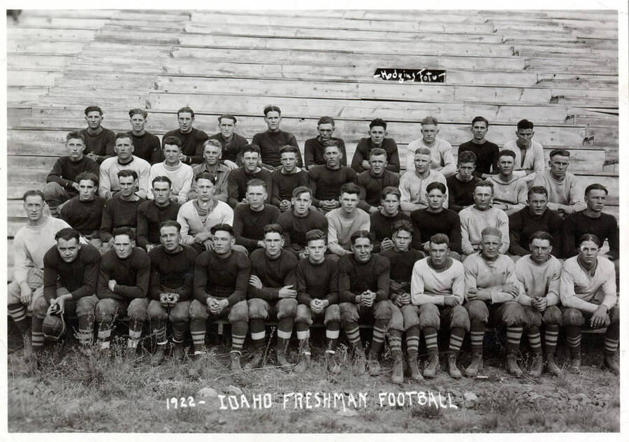 Photograph of the University of Idaho freshman football team sitting on the bleachers. Caption reads '1922 - Idaho Freshman Football.'