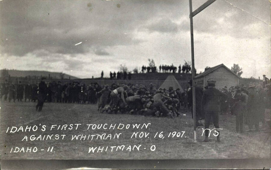 Photograph of the University of Idaho versus Whitman football game. Caption reads 'Idaho's First Touchdown Against Whitman, Nov. 16, 1907, Idaho-11, Whitman-0.'
