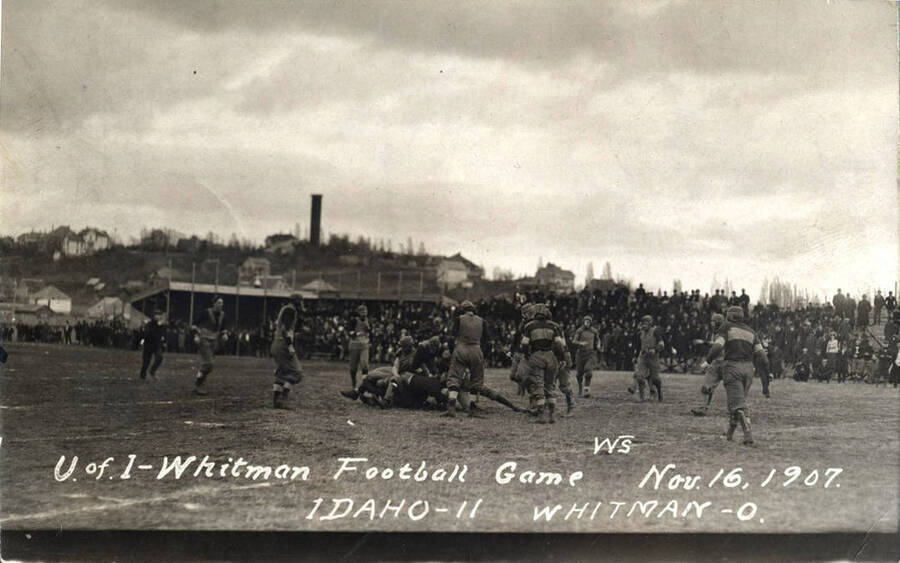 Photograph of the University of Idaho versus Whitman football game. Caption reads 'U of I-Whitman Football Game, Nov. 16, 1907, Idaho-11 Whitman-0.'