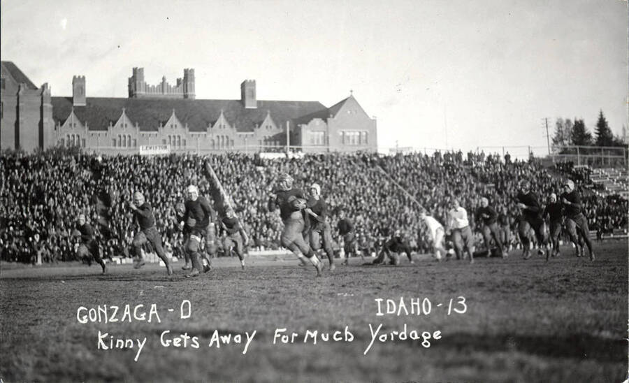 Photograph of the University of Idaho versus Gonzaga football game. Caption reads 'Gonzaga-0, Idaho-13, Kinny Gets Away for Much Yardage.'