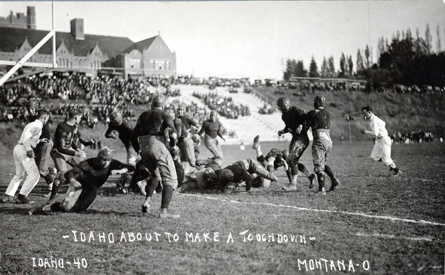Photograph of the University of Idaho versus Montana football game. Caption reads 'Idaho-40 ~Idaho About To Make A Touchdown~ Montana-0.'