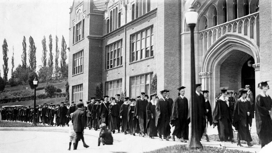 Graduates of the class of 1940 walk past the Administration Building as part of the traditional procession through campus to Commencement.