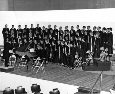 The Vandaleers at a performance holding candle sticks.