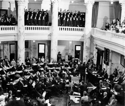 The Vandaleers perform excerpts from the pageant 'Light on the Mountain' in the legislative chambers before the combined House and Senate in celebration of the Idaho Centennial.