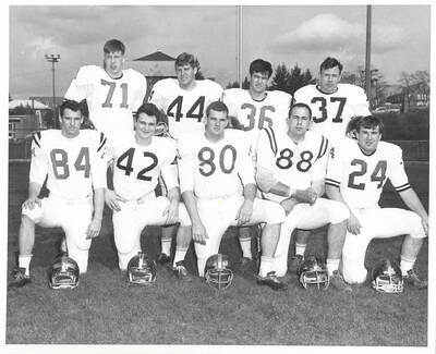 A group of nine unidentified University of Idaho football players grouped and posed together for the photograph.