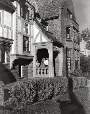Students standing the in doorway of the Phi Gamma Delta house, which is on the northwest corner of University Avenue and Elm Street.