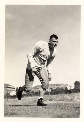 Paul Ryan, end for the University of Idaho football team, running along the football field.