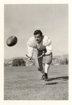 University of Idaho football player, Savino Uberuaga, leaning into his stride to catch the football for an action shot.