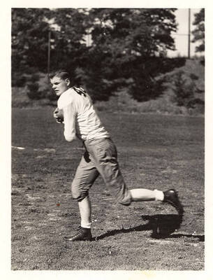 Right end for the University of Idaho Chace Anderson, running along the field with a football.