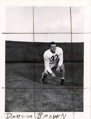 Darwin Brown (#32), a guard for the University of Idaho football team, crouching on the football field.