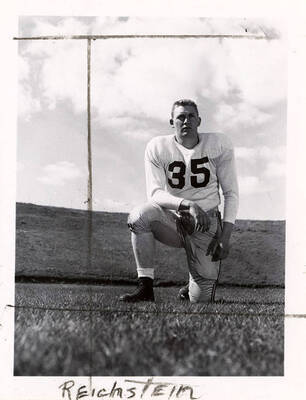 DeLloyd Reichstein (#35), a football player for the University of Idaho, kneeling on the field.