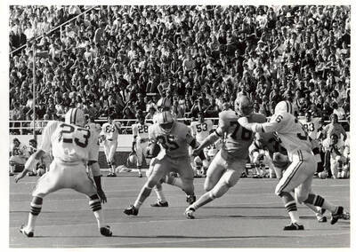 The Vandals have the ball while other players kneel on the sidelines and the crowded audience watches in anticipation.