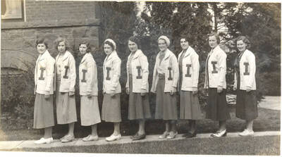 I Club members standing outside of the Women's Gym for a group photo.