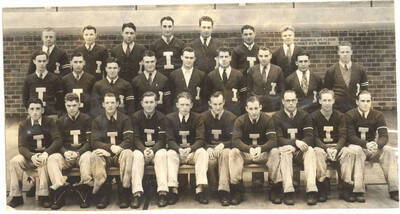 I Club members pose together for a group photo beside the Memorial Gym.