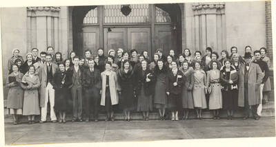The English Club stands in front of the Administration building for a group photo.