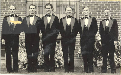 Six members of the Blue Bucket dance band pose for a photo in their performance attire.