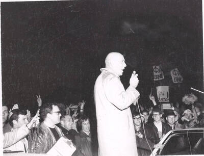 Iver Longeteig, president of Alumni Association, addresses students and faculty gathered on President Hartung's lawn.