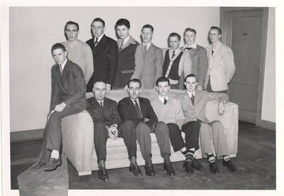 Group photo of the Chemical Engineer club members around a couch, posing for a photo together.