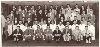 Idaho Club members crowded together in a room for a photo. Individuals identified on mount.