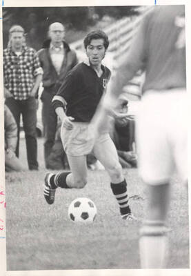 A University of Idaho soccer player dribbles the ball down the pitch.